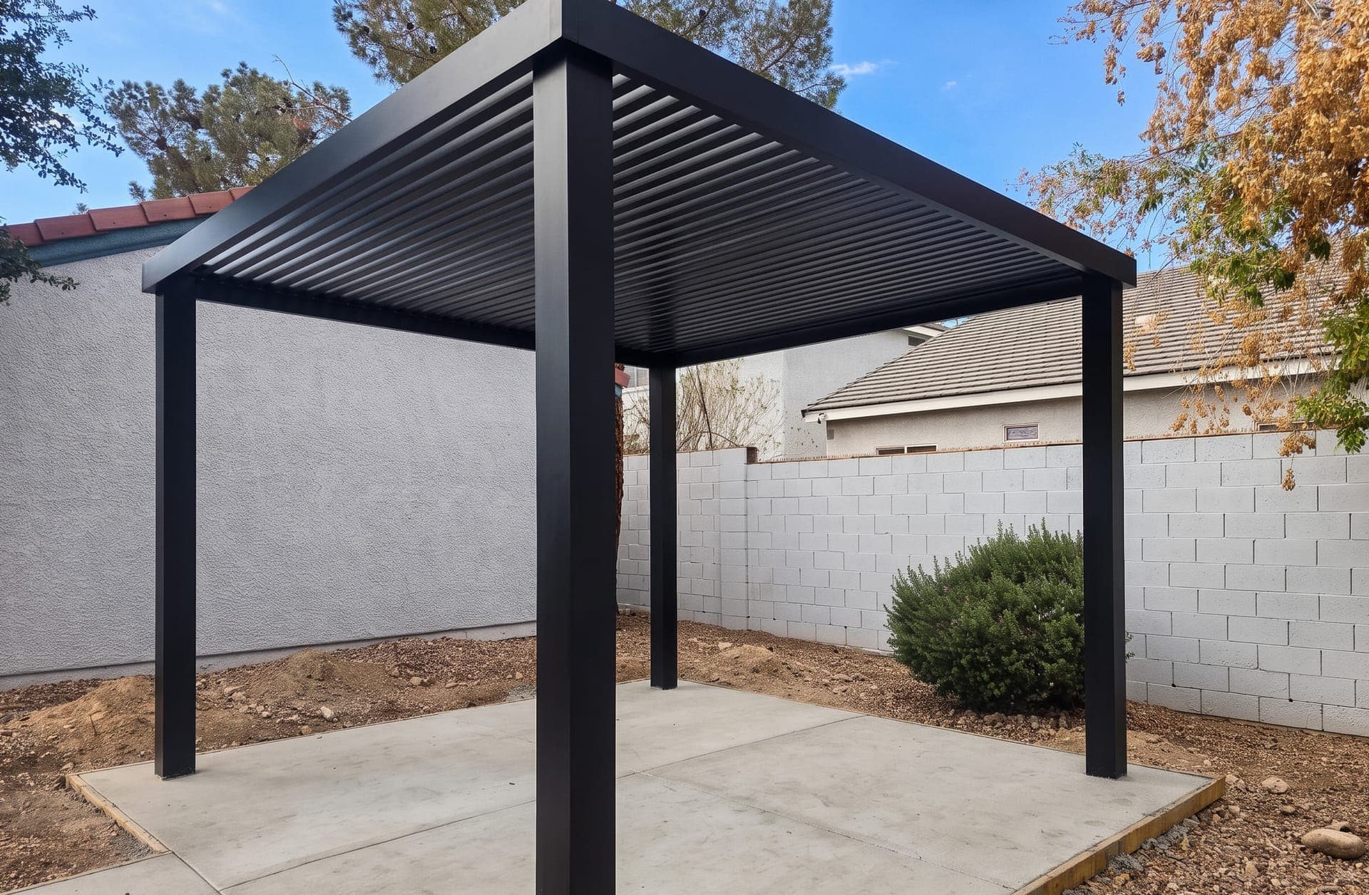 Black 4K Aluminum freestanding lattice cover on a new concrete slab in a backyard