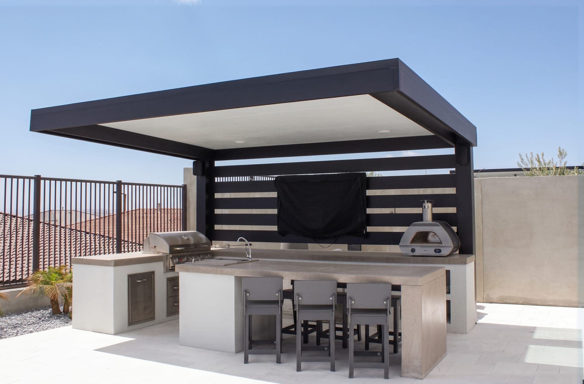 4K Aluminum cantilever cover with a solid roof and a slat privacy wall over an outdoor kitchen on a hillside terrace